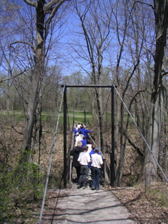 Performing Choir crossing bridge at Ska-Nah-Doht Iroquoian Village