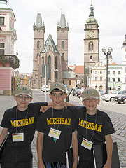 3 Choristers in front of cathedral in Hradec Kralove, Czech Republic